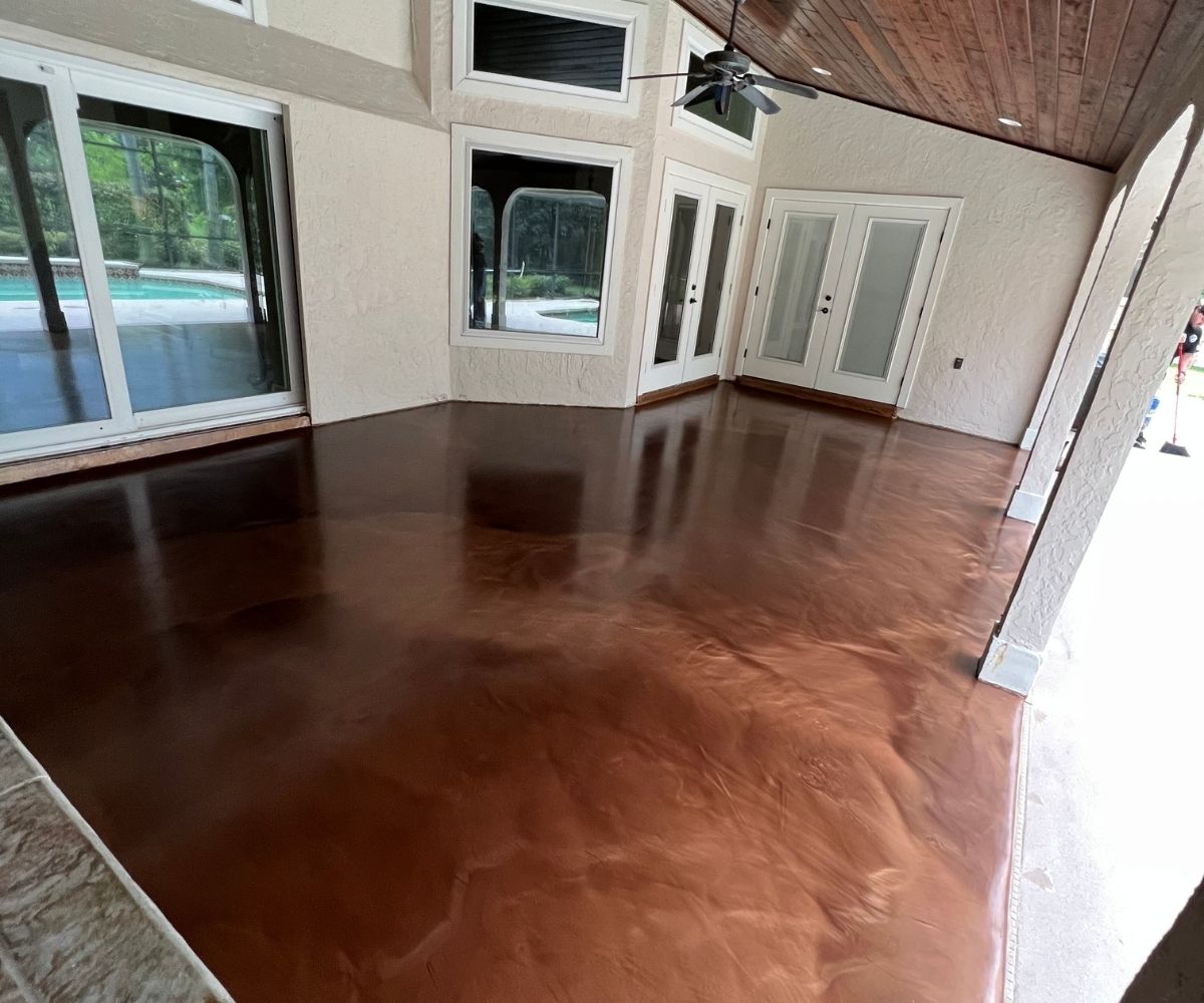 Copper metallic epoxy floor finish on a covered lanai overlooking the pool in Saint Augustine, Florida