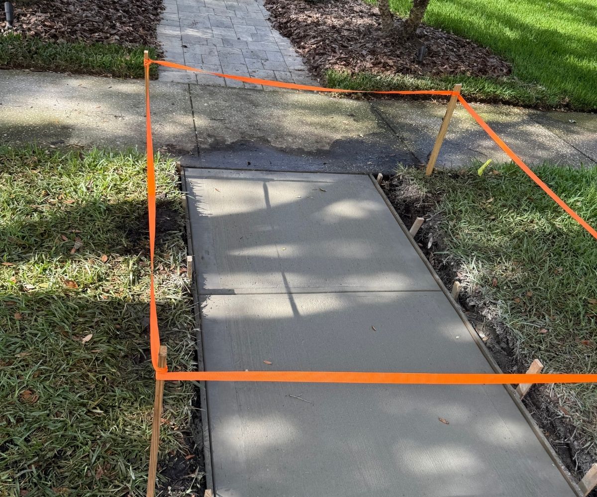 Freshly poured concrete sidewalk section curing in Saint Augustine, Florida