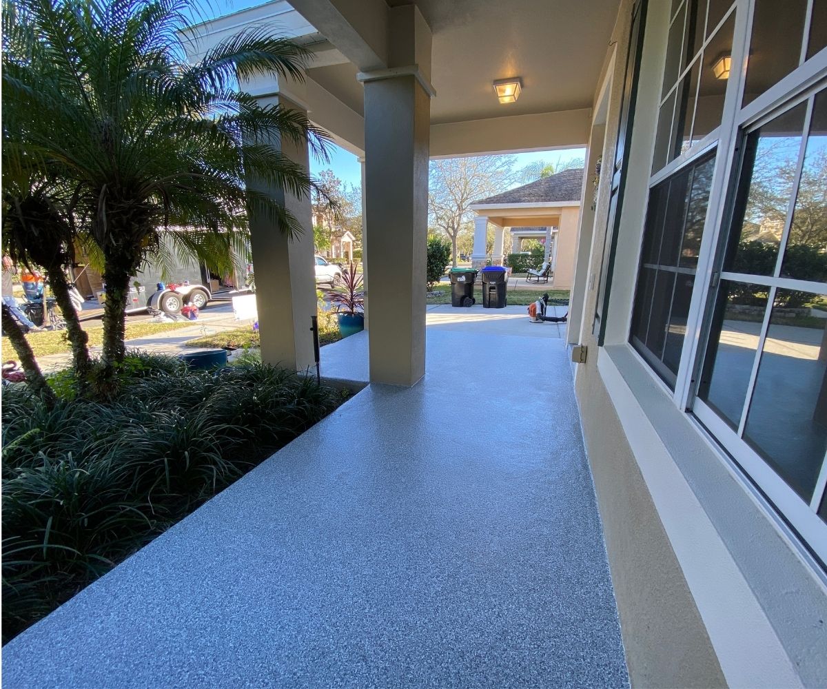 Finished gray concrete coating on a front porch in Saint Augustine, Florida