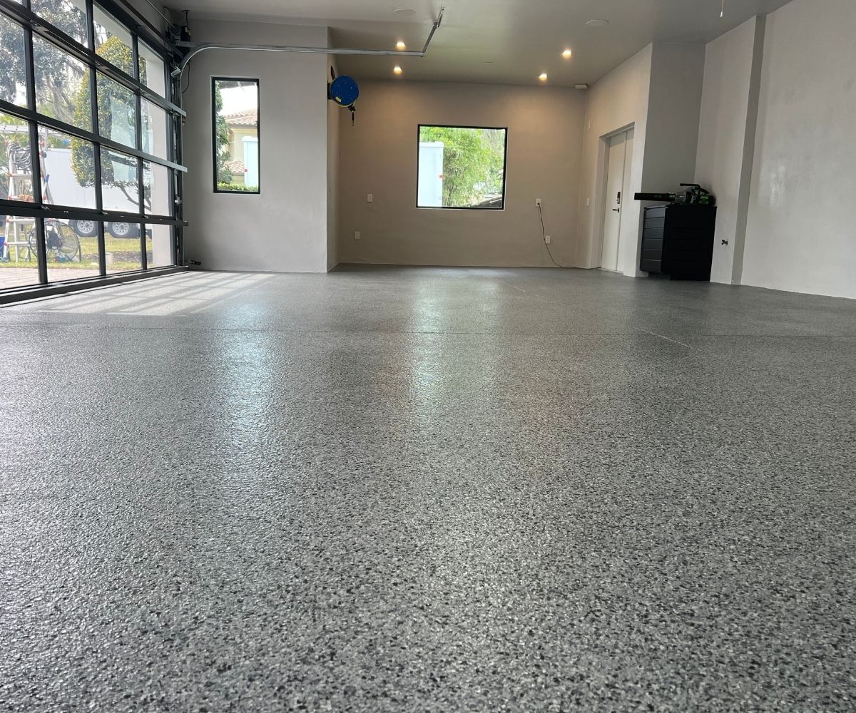 Completed gray full-flake garage floor coating, full room view, in Saint Augustine, Florida