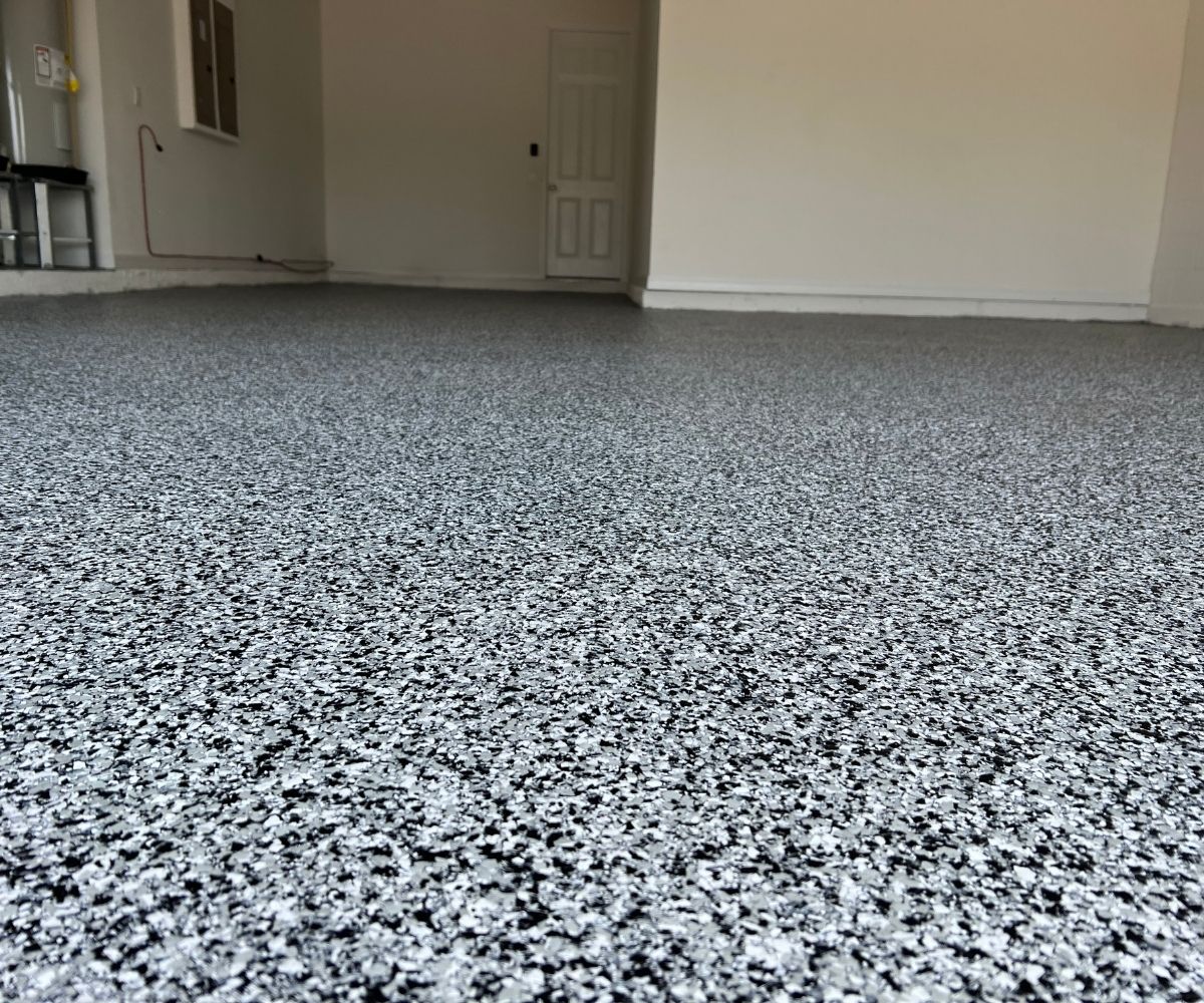 Close-up of gray, black and white flake garage floor coating in Saint Augustine, Florida
