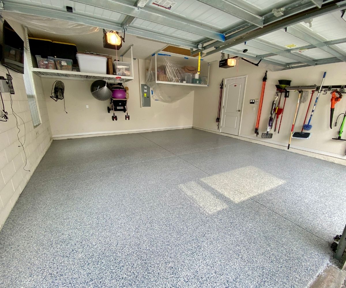 Finished blue-gray flake epoxy garage floor with overhead storage in Saint Augustine, Florida