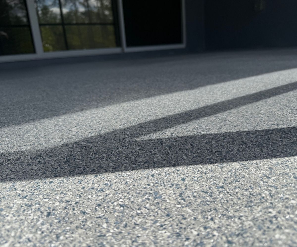 Close-up of full-flake garage floor texture under polyaspartic topcoat in Saint Augustine, Florida