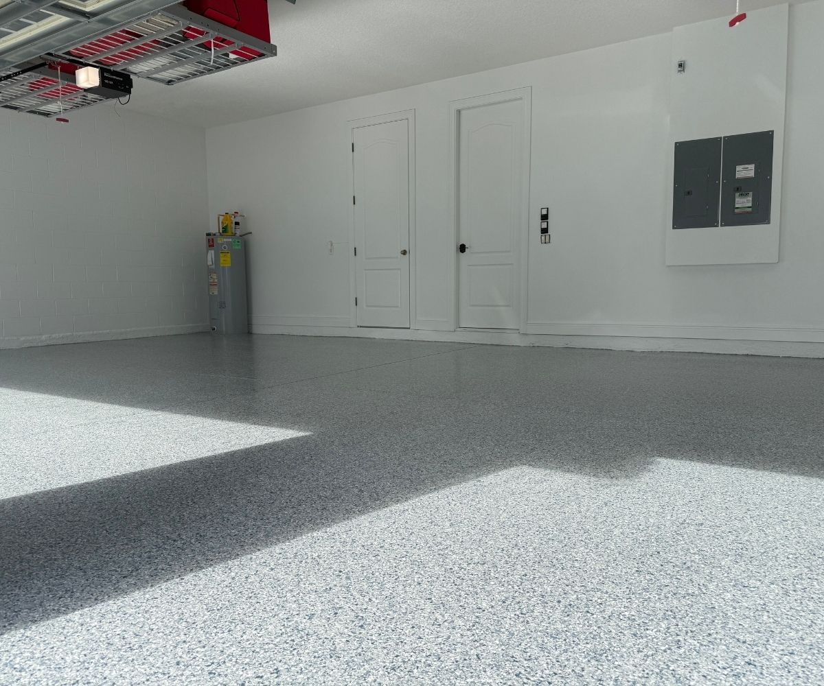 Finished gray flake epoxy garage floor with shelving reinstalled in Saint Augustine, Florida