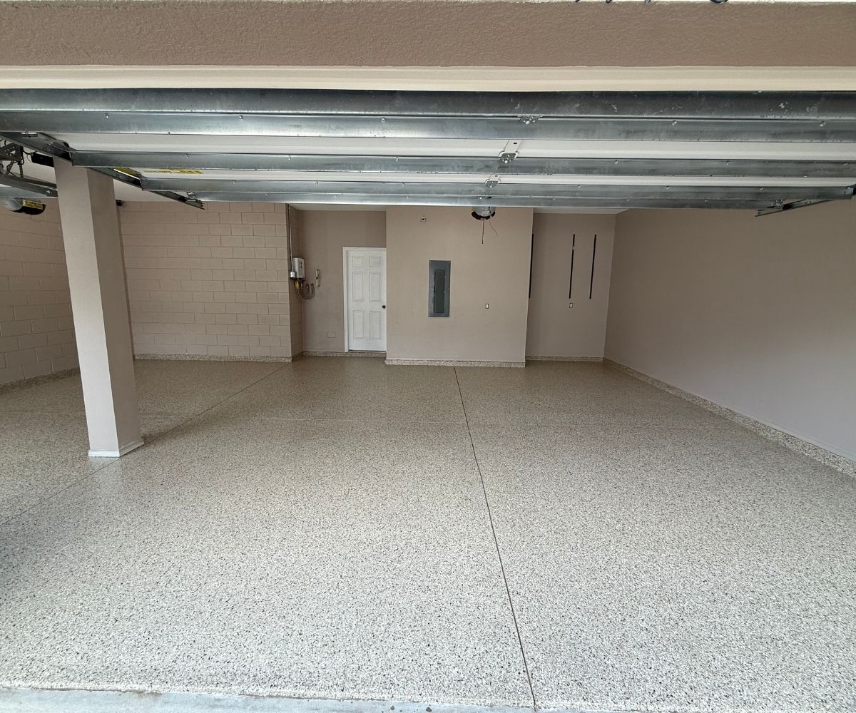 Finished tan full-flake epoxy and polyaspartic coating on a three-car garage floor in Saint Augustine, Florida