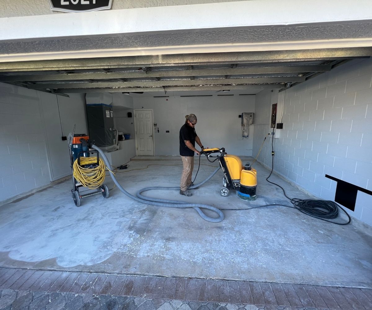 Crew diamond-grinding a garage floor slab for mechanical bond in Saint Augustine, Florida