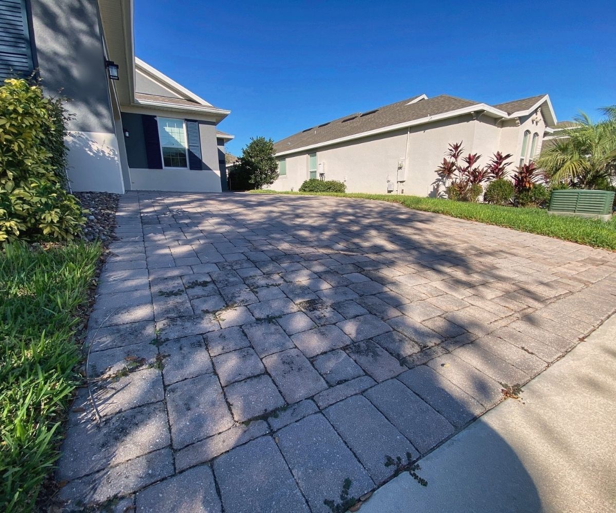 Weathered, faded paver driveway before sealing in Saint Augustine, Florida
