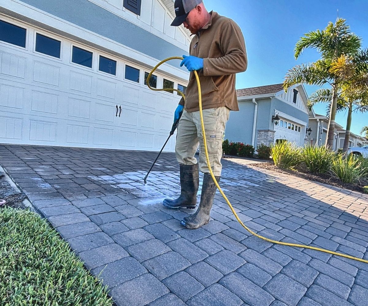 PD Home Pros crew applying sealer to a paver driveway in Saint Augustine, Florida