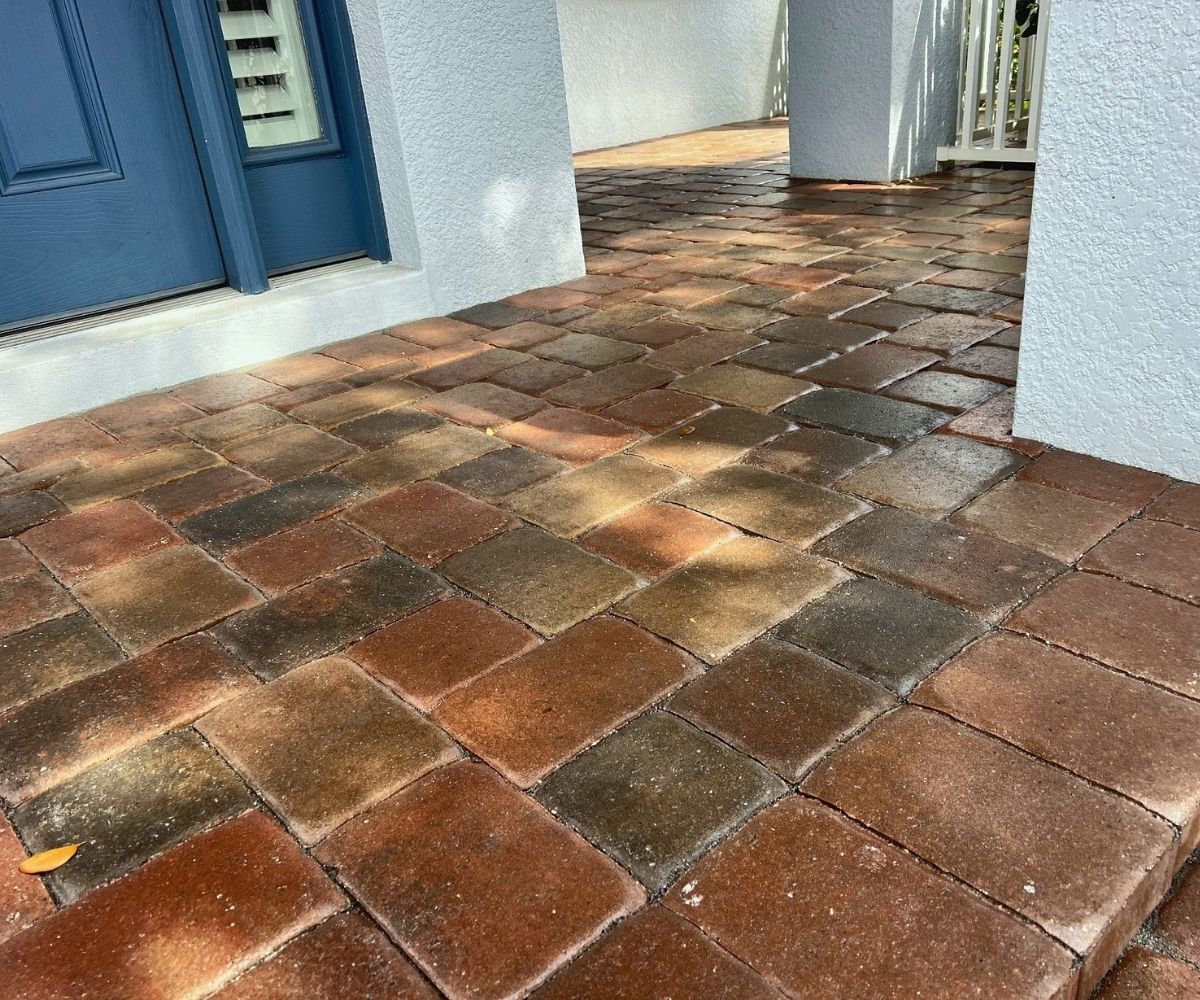 Wet look sealer deepening the multi-tone color of an entryway paver walkway in Saint Augustine, Florida