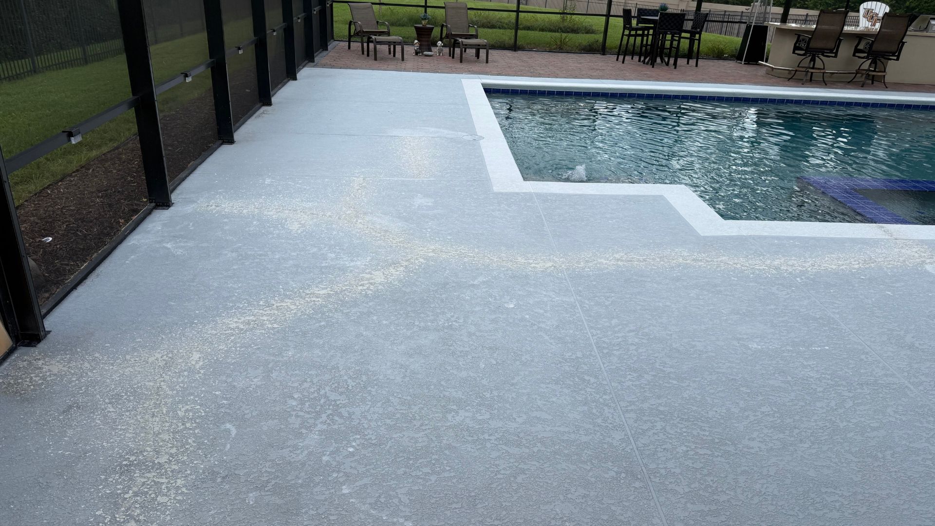 Finished light gray concrete coating on a pool deck in Saint Augustine, Florida