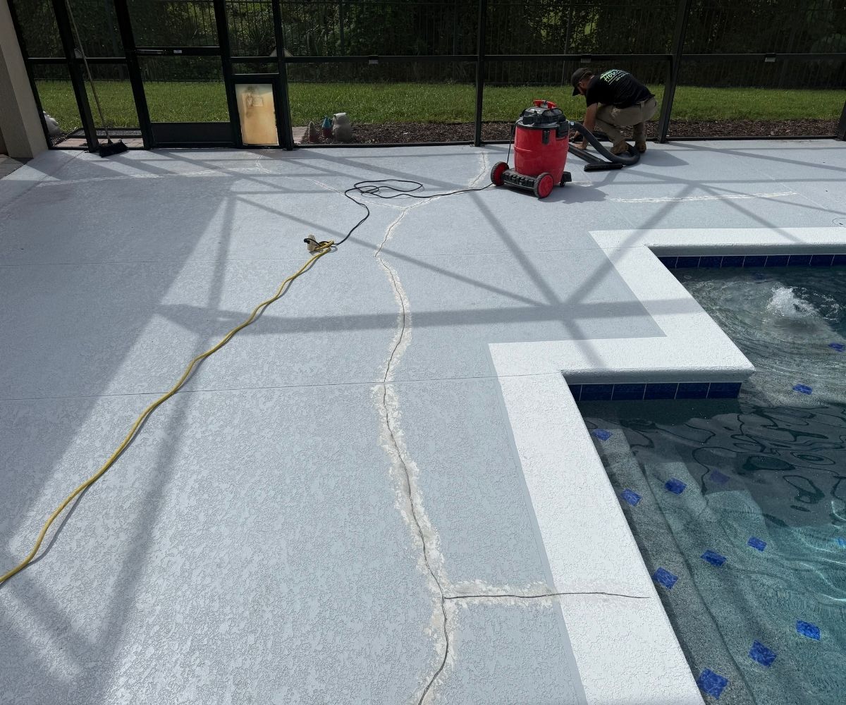 Crew repairing cracks in a cool deck pool surface in Saint Augustine, Florida