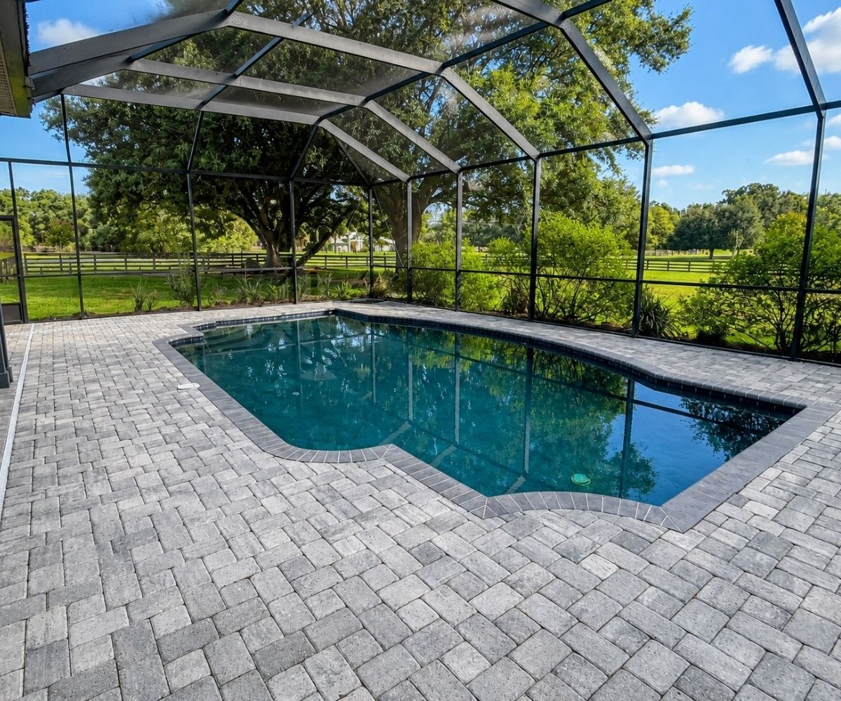 Finished gray paver pool deck on a screened lanai in Saint Augustine, Florida