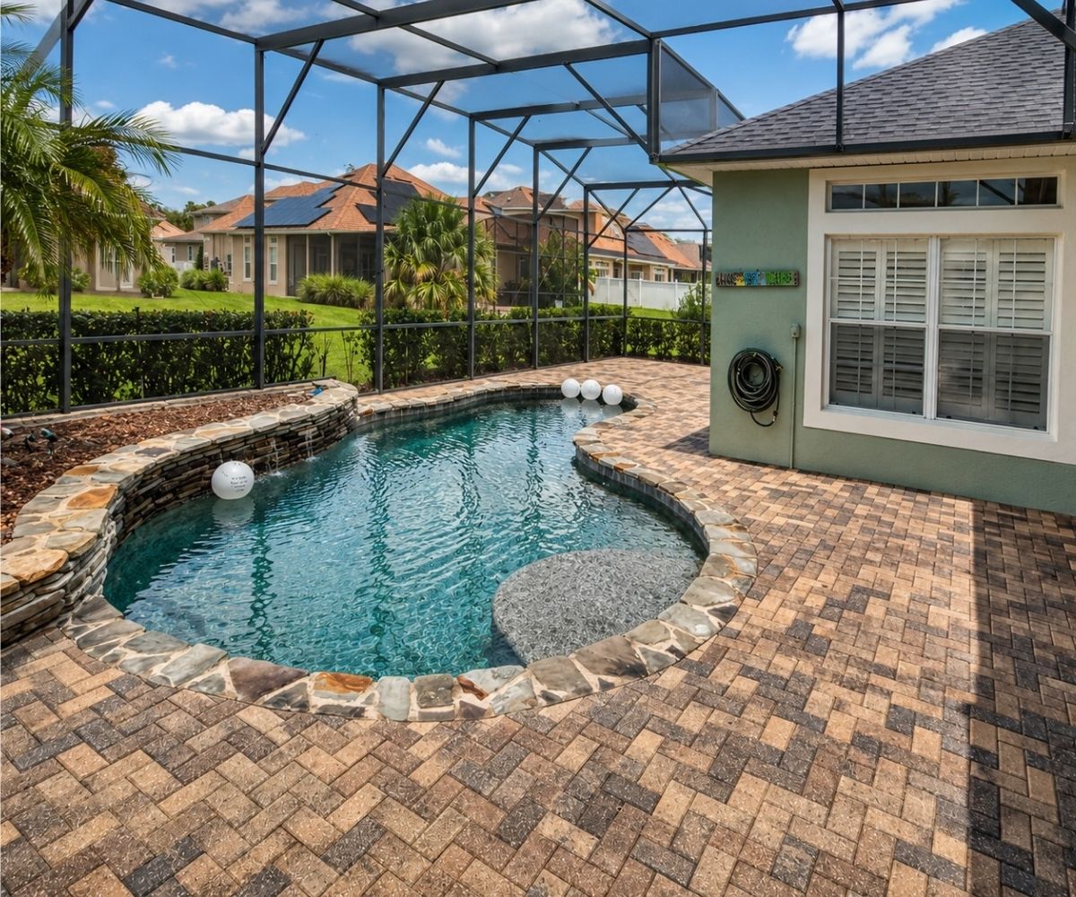 Finished tan and brown paver pool deck in Saint Augustine, Florida