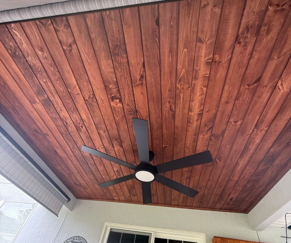 Finished stained shiplap ceiling with new ceiling fan on a lanai in Saint Augustine, Florida