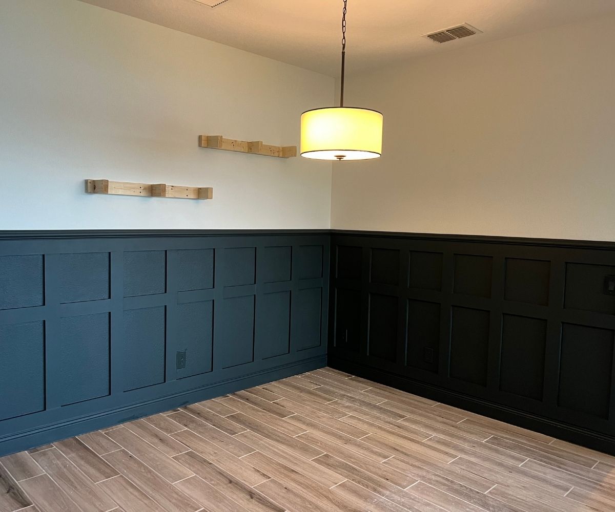 Finished navy and black wainscoting accent wall in a dining room in Saint Augustine, Florida